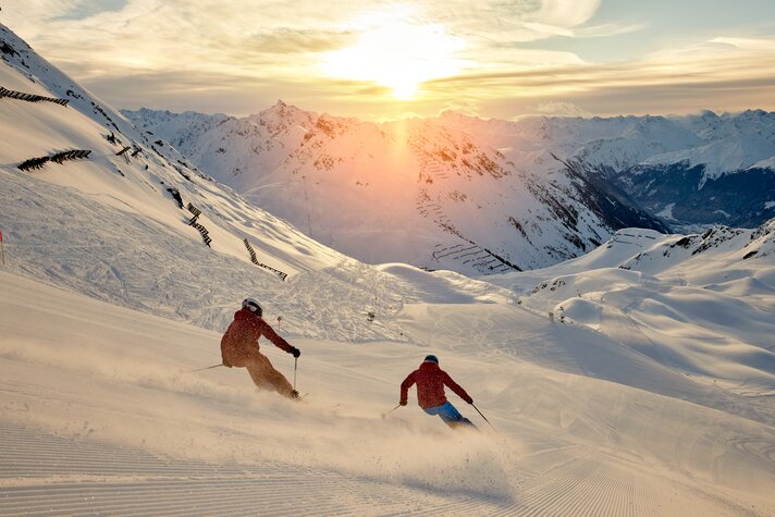 HochjochTotale - Silvretta Montafon | ©  Silvretta Montafon - Stefan Kothner Zwei Skifahrer fahren über die frisch präparierte Piste bei Sonnenaufgang bei der HochjochTotale in der Silvretta Montafon | ©  Silvretta Montafon - Stefan Kothner